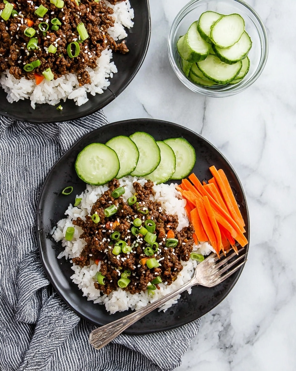 The image shows two black plates with white rice as the first layer. On top of the rice is a second layer of dark brown cooked ground meat mixed with small green pieces, sprinkled with white sesame seeds and chopped green onions. One plate includes an extra third layer of thinly sliced cucumber rounds and thin orange carrot sticks arranged on one side. A silver fork rests on one plate near the food. A small clear glass bowl with cucumber slices sits nearby. The entire setting is on a white marbled surface with a gray and white striped cloth near the plates. Photo taken with an iphone --ar 4:5 --v 7