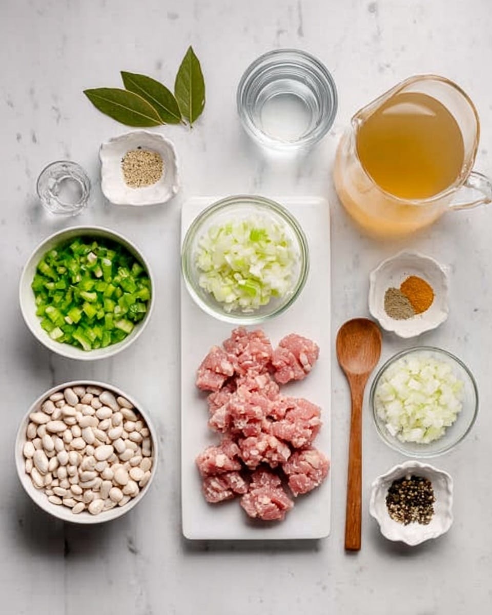 The image shows a white rectangular plate with small pieces of raw pink meat at the center top. Around it, arranged on a white marbled surface, are small white bowls and glass containers holding various ingredients: a round white bowl with white beans on the bottom left, two smaller clear glass bowls with chopped green bell peppers and sliced green onions next to it, a white bowl with diced white onions near the center, a small white dish with dry spices including black pepper, turmeric, and bay leaves on the top left, a glass cup of clear water on the top right, and a glass jug of light golden broth near it. A small wooden spoon lies beside the beans bowl. The setup looks clean and organized, ready for cooking photo taken with an iphone --ar 4:5 --v 7