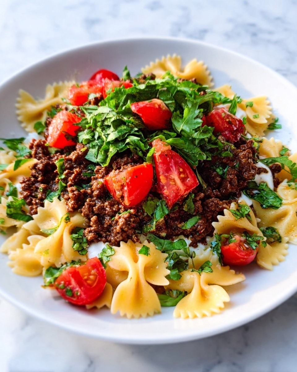 The image shows a white plate on a white marbled surface filled with three layers of food. The bottom layer consists of light yellow pasta with a bow-tie shape, arranged evenly across the plate. The middle layer is a rich, dark brown ground meat sauce spread over the pasta. On top, there are bright red tomato pieces and fresh green leafy herbs scattered around, adding color and texture. A woman's hand is holding a fork from the left side, reaching toward the plate. The photo is taken with an iphone --ar 4:5 --v 7