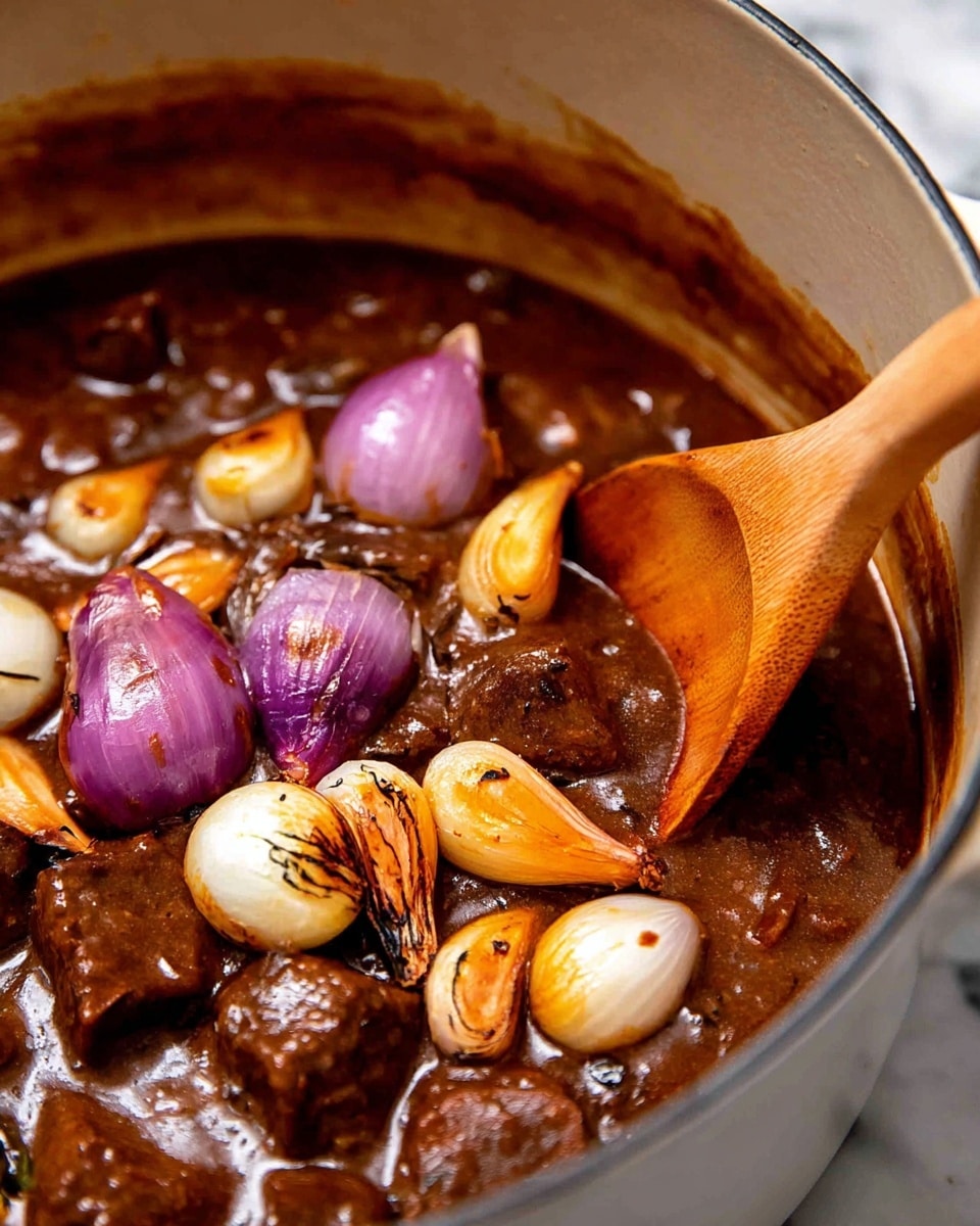 This close-up image shows a rich brown stew with soft, tender pieces immersed in a thick sauce. On top of the stew, there is a layer of lightly browned small onions and purple shallot halves, some with charred edges, giving a mix of creamy white, golden brown, and purple colors. A wooden spoon is stirring the stew from the right side, showing the texture of the sauce. The dish is inside a white pot, and the background has a white marbled texture. photo taken with an iphone --ar 4:5 --v 7