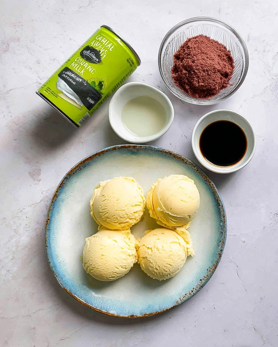 The image shows four scoops of light yellow ice cream placed evenly on a white plate with a slightly worn blue rim. Above the plate, there is a clear glass bowl with a rough textured reddish-brown paste. Next to it are two small white bowls, one containing a thick black liquid and the other with a light clear liquid. A green can of organic coconut milk is tilted on its side to the left of the bowls, standing out with its bright color against the white marbled surface. photo taken with an iphone --ar 4:5 --v 7