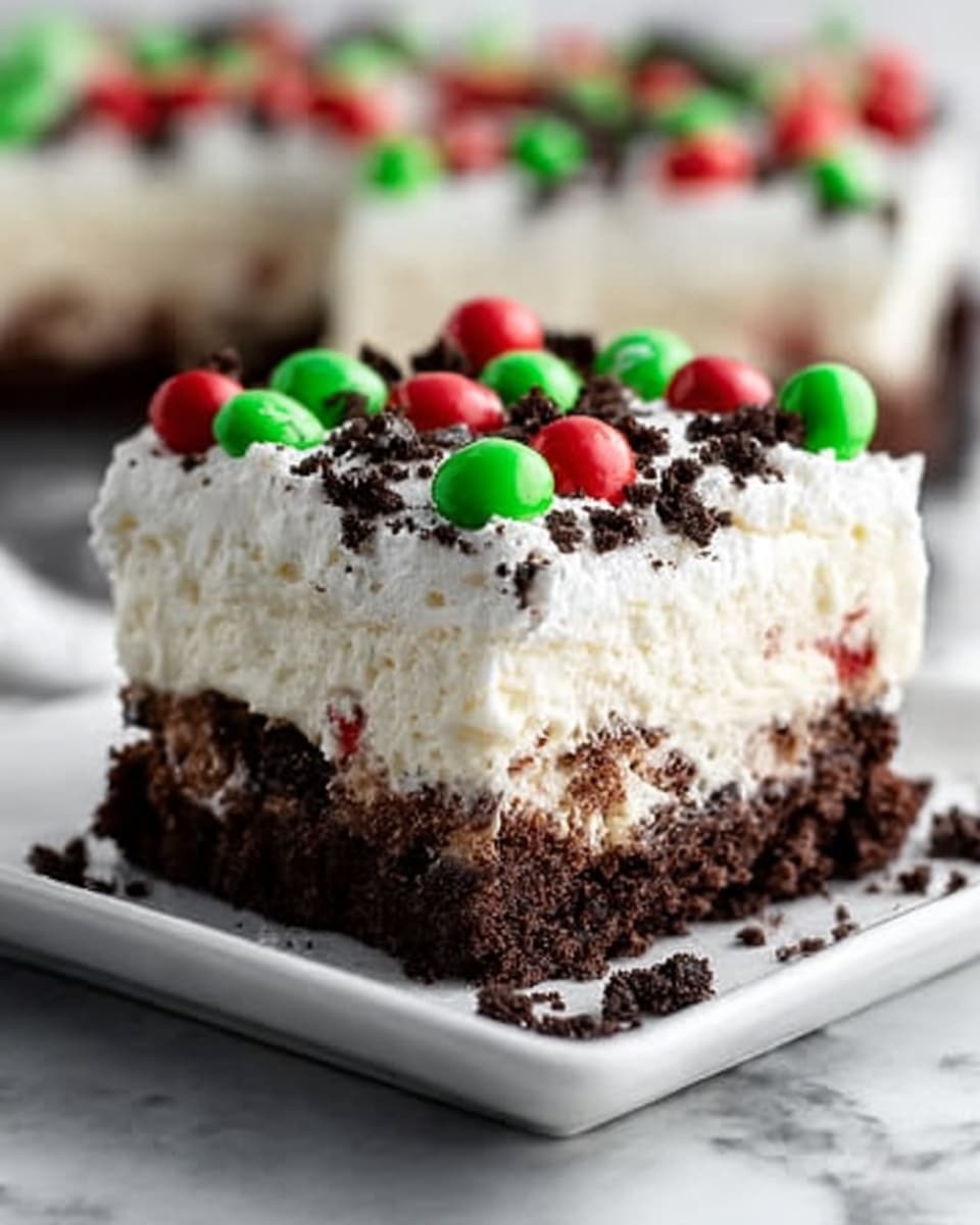 The image shows three square layered dessert pieces on a glass plate. Each piece has a thick bottom layer of dark brown crumbly texture, topped by a creamy white layer that looks soft and smooth. Above this creamy layer, there is a thin sprinkle of crushed dark brown crumbs and small chocolate pieces. On top of everything, there is a thick white frosting layer spread unevenly, decorated with green and red candy pieces and tiny round dark chocolate bits. The background is a white marbled texture. Photo taken with an iphone --ar 4:5 --v 7