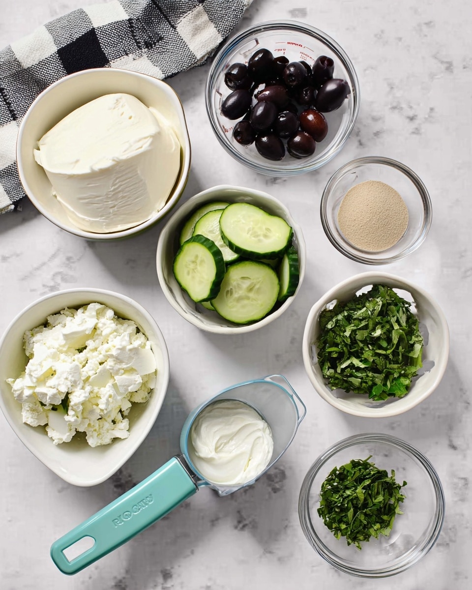 A collection of small white bowls and glass dishes on a white marbled surface hold various fresh ingredients: one bowl with thick white cream cheese, another with green cucumber slices, a small bowl with black olives, a measuring cup with white sour cream, two glass dishes with chopped green herbs, and a small bowl with a light brown powder. A black and white checkered cloth is placed at the top. Photo taken with an iphone --ar 4:5 --v 7