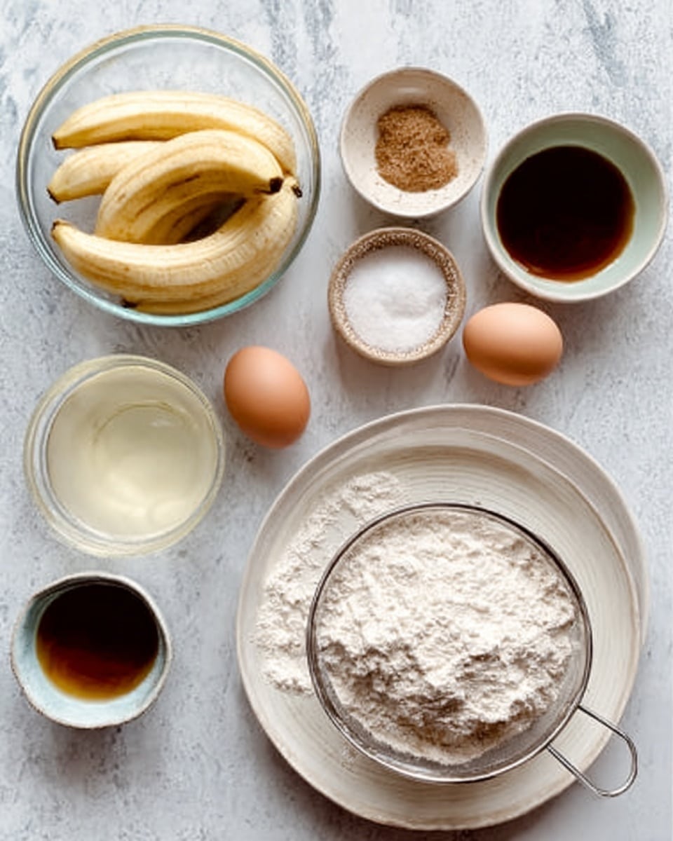The image shows a white marbled surface with a clear glass bowl in the center containing peeled bananas, next to two whole eggs, a small bowl of clear liquid, and a small bowl of brown sugar. Nearby is a bowl with a dark liquid, another small bowl with salt, and a large white plate with a fine mesh sieve filled with white flour. The flour is piled in the sieve resting above the plate. Everything is arranged neatly with soft natural light. Photo taken with an iphone --ar 4:5 --v 7