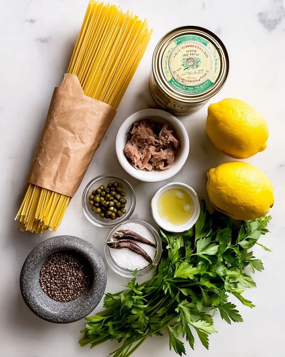 The image shows a set of cooking ingredients on a white marbled surface. On the left, there is a tall rectangular brown paper bag filled with yellow spaghetti pasta, standing upright. To the right of the bag, there is an open round metal can with chunks of brown tuna inside. Next to it is a small white bowl filled with coarse white salt. Below the tuna can, there is a small white bowl holding a few brown anchovy fillets. Right beside it, there is a small clear glass jar filled with green capers, and next to that, a tiny glass bowl containing a small amount of pale yellow olive oil. Under these bowls, there is a bunch of fresh green parsley with leafy stems spread out. Near the parsley, at the bottom left, there is a thick round grey stone bowl full of coarse black pepper. To the right of the parsley, there are two whole yellow lemons placed close to each other. Photo taken with an iphone --ar 4:5 --v 7