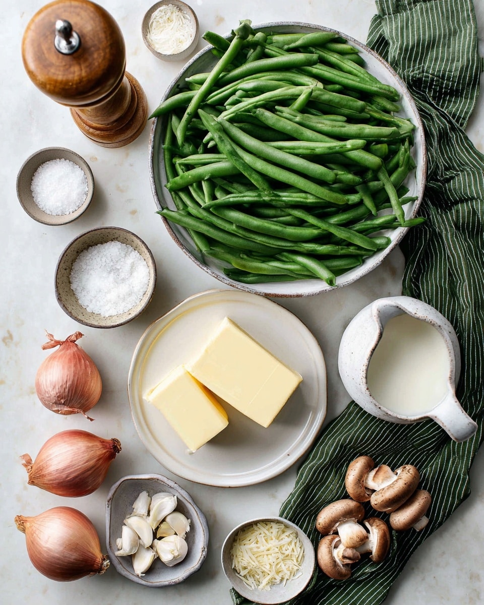 A large bowl filled with long, fresh green beans sits in the upper middle of the image. Below the bowl, there is a white plate with two blocks of yellow butter on it. To the left of the green beans is a small white bowl filled with coarse salt, and above it stands a wooden pepper grinder. Around the bottom of the image, there are several shallots with reddish skins, a small gray bowl with garlic cloves and a nutmeg, a small bowl filled with grated Parmesan cheese, and a white pitcher filled with milk. To the right, some brown mushrooms rest on a green striped cloth on a white marbled surface. Photo taken with an iphone --ar 4:5 --v 7